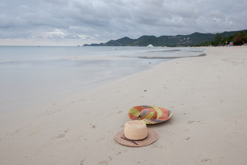 Obraz premium Beach on tropical island. Clear blue water, sand, clouds. 