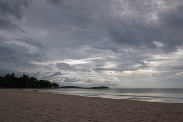 Beach on tropical island. Clear blue water, sand, clouds. 