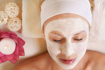Young beautiful girl receiving facial mask in spa beauty salon.  Skin care, Beauty treatments.