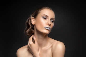 Fototapeta premium High fashion look, closeup beauty portrait of beautiful young woman model with bright makeup with perfect clean skin with colorful blue lips. Beautiful girl with elegant hairstyle. Fashion photo