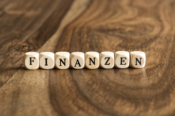 German word FINANZEN on wooden cubes