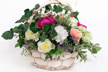 gift basket of flowers whith roses peonies hydrangea isolated