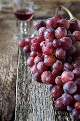 Bunch of red grapes and wineglass