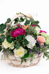 gift basket of flowers whith roses peonies hydrangea isolated