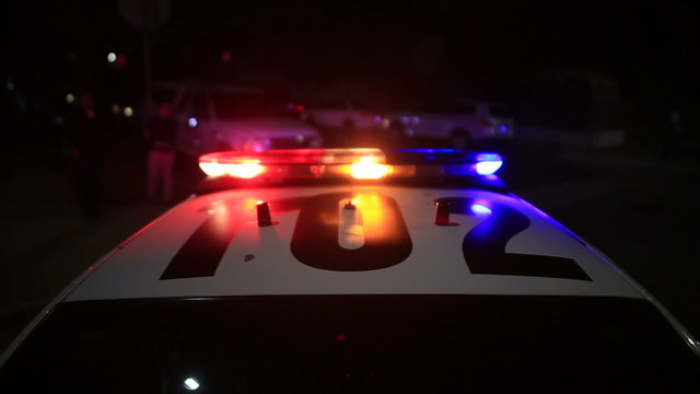 Actual LAPD Police activity in neighborhood involving police cars, sirens, choppers at night in Los Angeles, California