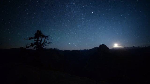 3 axis motion controlled astrophotography time lapse footage with dolly up / tilt down/ pan right motion of milky way and moon rise over Half Dome at Glacier Point in Yosemite National Park, California