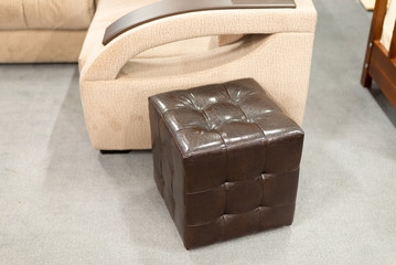 Brown leather ottoman in  interior of the apartment