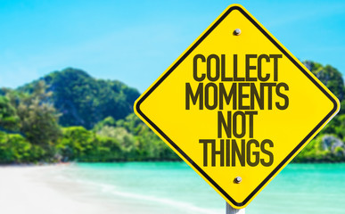 Collect Moments Not Things sign with beach background