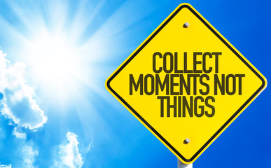 Collect Moments Not Things sign with sky background