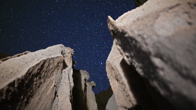 3 axis motion controlled astrophotography time lapse footage with dolly in, tilt up, pan left & zoom in motion of starry sky over eroded sandstone slot canyon at Red Rock Canyon State Park in Mojave Desert, California
