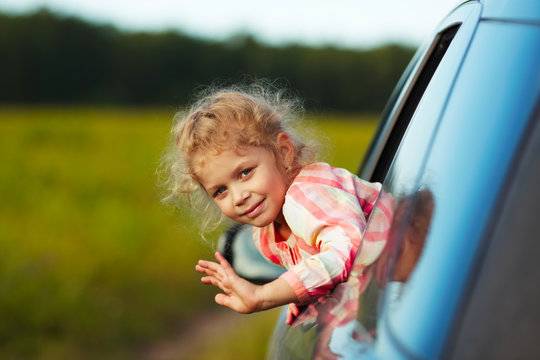 Little Girl Waving From Car Window