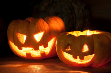 Fototapeta premium Selective focus bright light in pumpkins on wood .