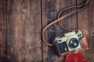 Old retro vintage camera on grunge wooden background - Powered by Adobe