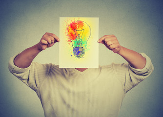 Man having brilliant idea colorful lightbulb covering face