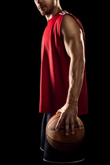 Basketball player holding ball isolated on black background
