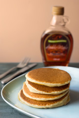 Maple syrup pouring onto pancakes. Shallow DOF with focus on syr