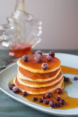Delicious pancake stack with fresh blueberries and dripping mapl