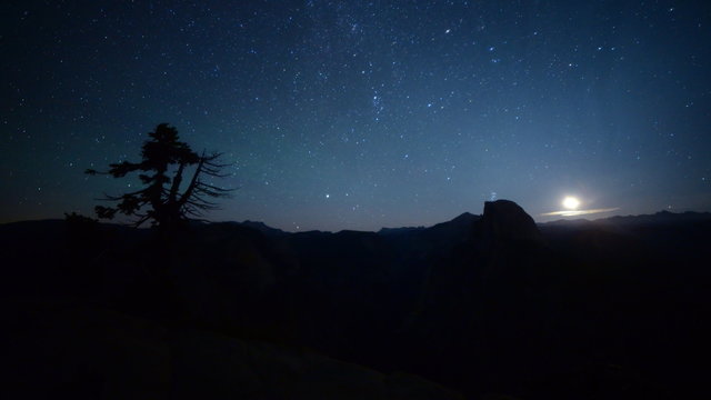 3 axis motion controlled astrophotography time lapse footage with dolly up / tilt down/ pan right / zoom in motion of milky way and moon rise over Half Dome at Glacier Point in Yosemite National Park, California