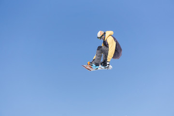 Snowboarder jumps in Snow Park