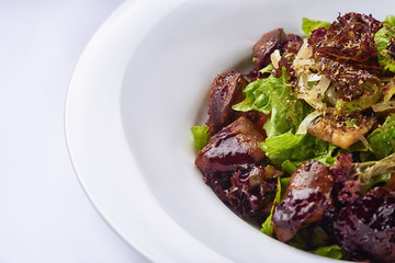 Warm salad with chicken on white background