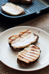 Crostini with fried cheese on the grill