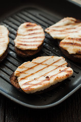 Crostini with fried cheese on the grill
