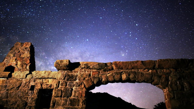  Astrophotography time lapse footage with pan left motion of milky way galaxy rising over abandoned brick ruin structure at Knapp's Castle in Santa Barbala, California