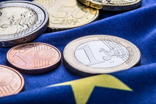 Euro coins. Euro currency. Euro money. European flag and euro money.  Coins and banknotes European currency freely laid on the European flag 