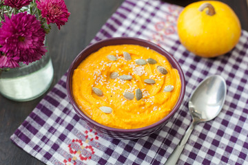 Pumpkin cream-soup with seeds in a bowl