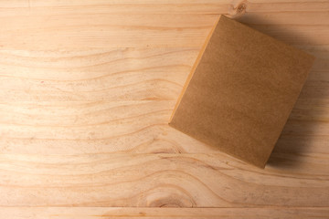 Opened cardboard box on wooden background