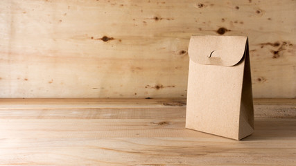 Fototapeta premium paper bag on wooden background