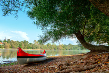 Red canoe on beach at river Danube