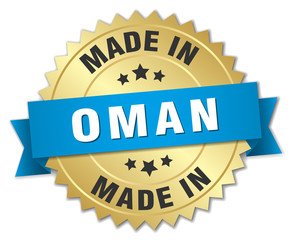 made in Oman gold badge with blue ribbon