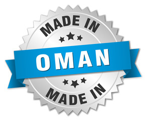 made in Oman silver badge with blue ribbon