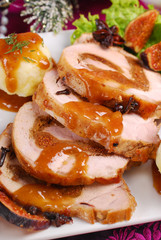 christmas dinner with loin of pork stuffed with figs and potato
