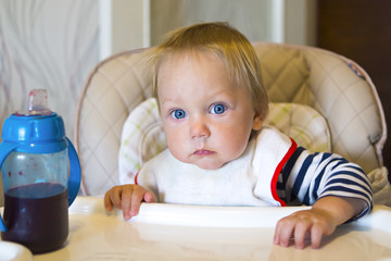 Small baby with bib at the table