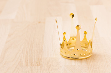 Golden crown with wood background