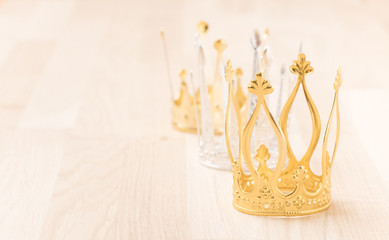 Three crowns with wood background