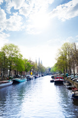 Sunny view of Amsterdam on the river and boats