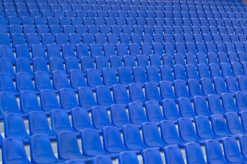 Rows of blue plastic seats on stadium