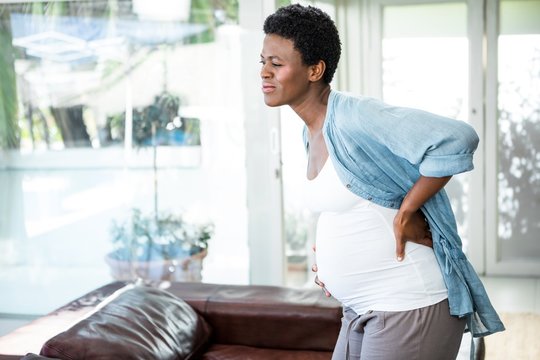 Pregnant woman struggling with a back pain