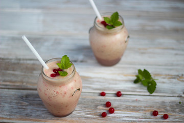 Fruit smoothie with mint leaves on wooden rustic table