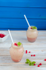 Fruit smoothie with mint leaves on wooden rustic table