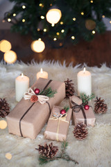 Naklejka na ściany i meble Christmas presents wrapped in front of the tree