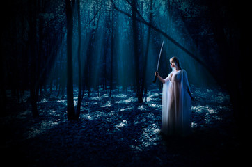 Elven girl with sword at night forest