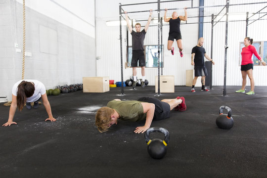 Workout group does exercises at fitness gym