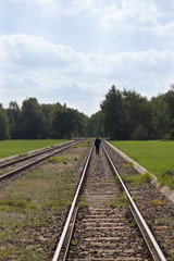 Fototapeta na wymiar man walking on railroad tracks