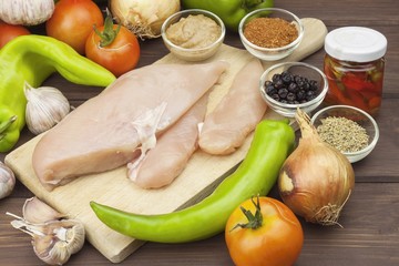 Preparing Diet food. Fresh raw chicken fillet and vegetables prepared for cooking. Fresh raw chicken breasts. Preparing chicken at a summer barbecue. Cooking with fresh dietary ingredients.