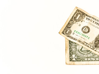 two usa dollars lay over white, business symbol for wealth and gain, over white, copy space on the left