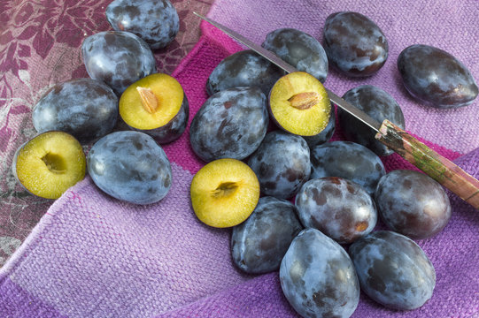 Fresh plums on a purple background